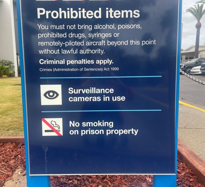 Sign outside a correctional centre listing Prohibited items and includes: No smoking on prison property. 