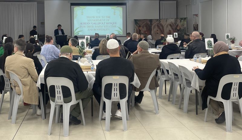 Luke Grant speaking to a room of Eid guests 
