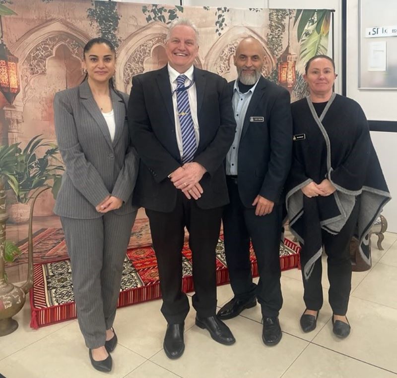 4 Corrective Services NSW staff standing together in front of Eid photo backdrop