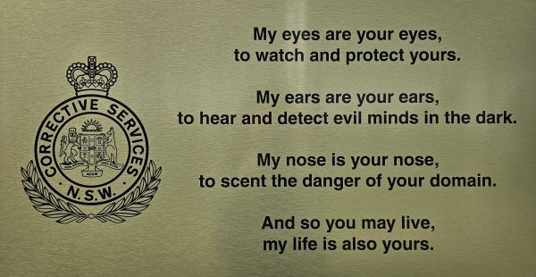 Metal plaque with engraved text: My eyes are your eyes, to watch and protect yours. My ears are your ears to hear and detect evils minds in the dark. My nose is your nose, to scent the danger of your domain. And so you may live, my life is also yours. 