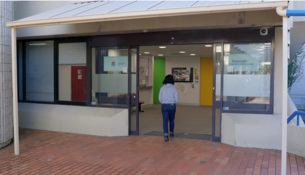 A woman walking into an office building